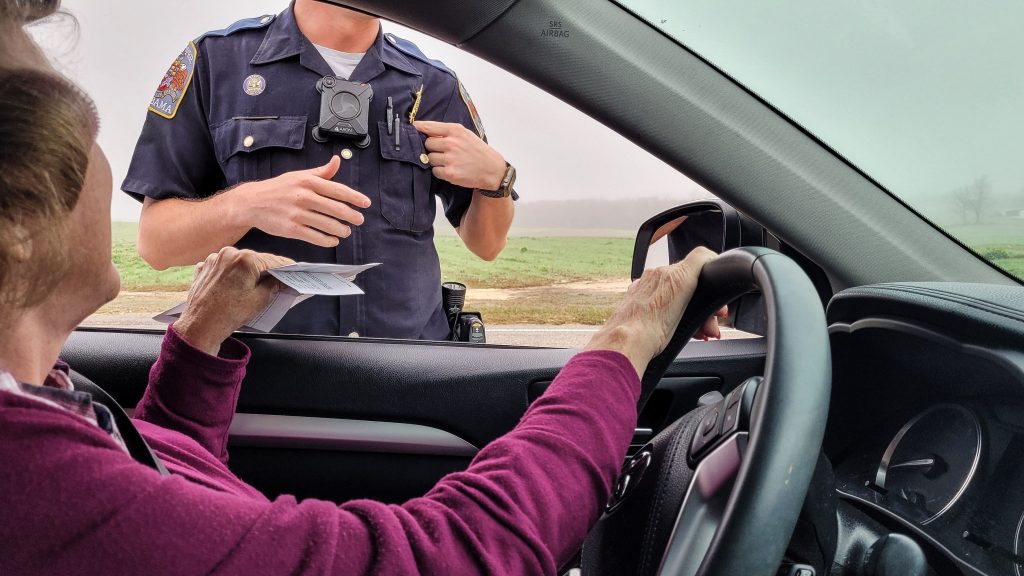 Police officer giving a woman a ticket.