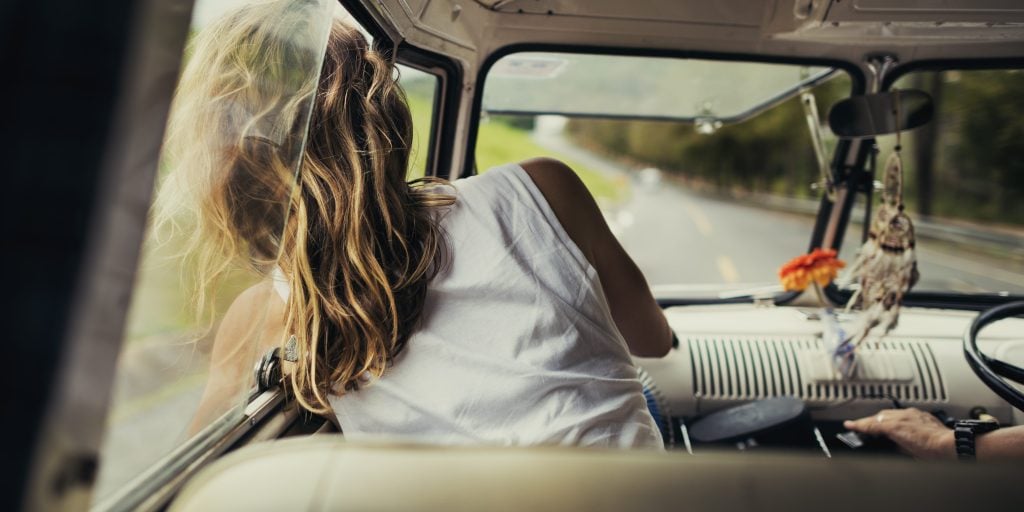 Woman looking out car window while driving a pickup truck