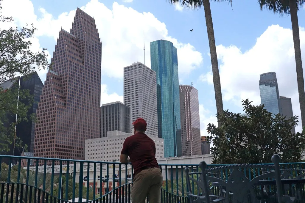 Man posing looking at Houston skyline.
