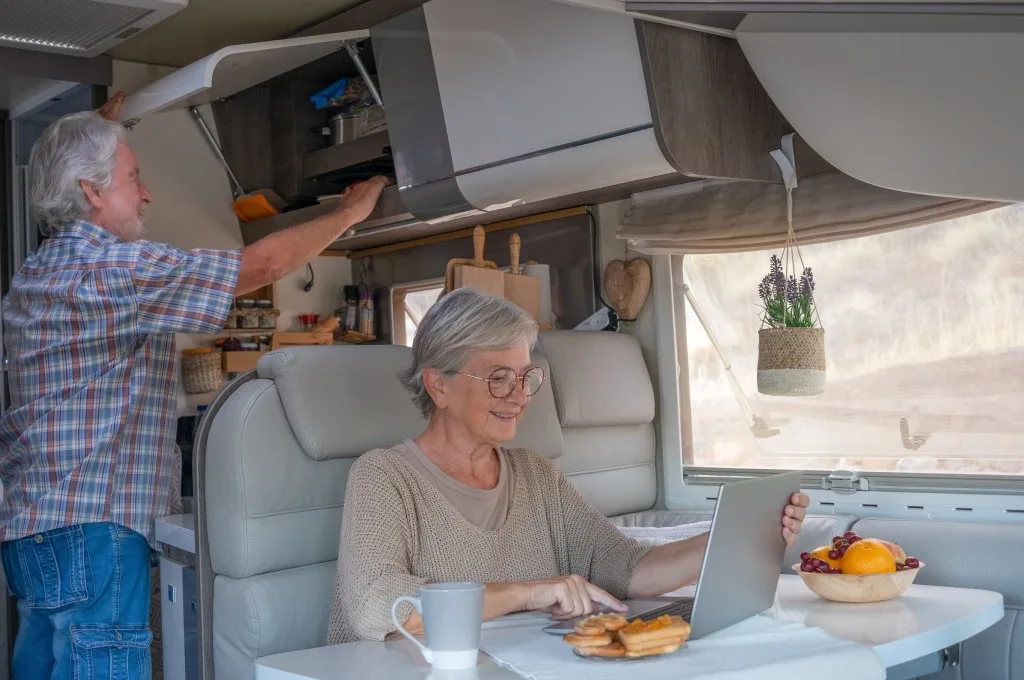Elderly couple using Starlink RV while scrolling through the web in RV