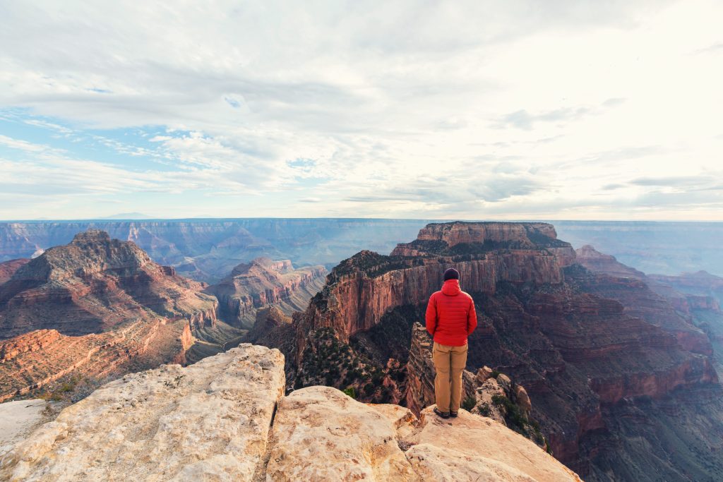 Man standing on the edge of a cliff in the Grand Canyon