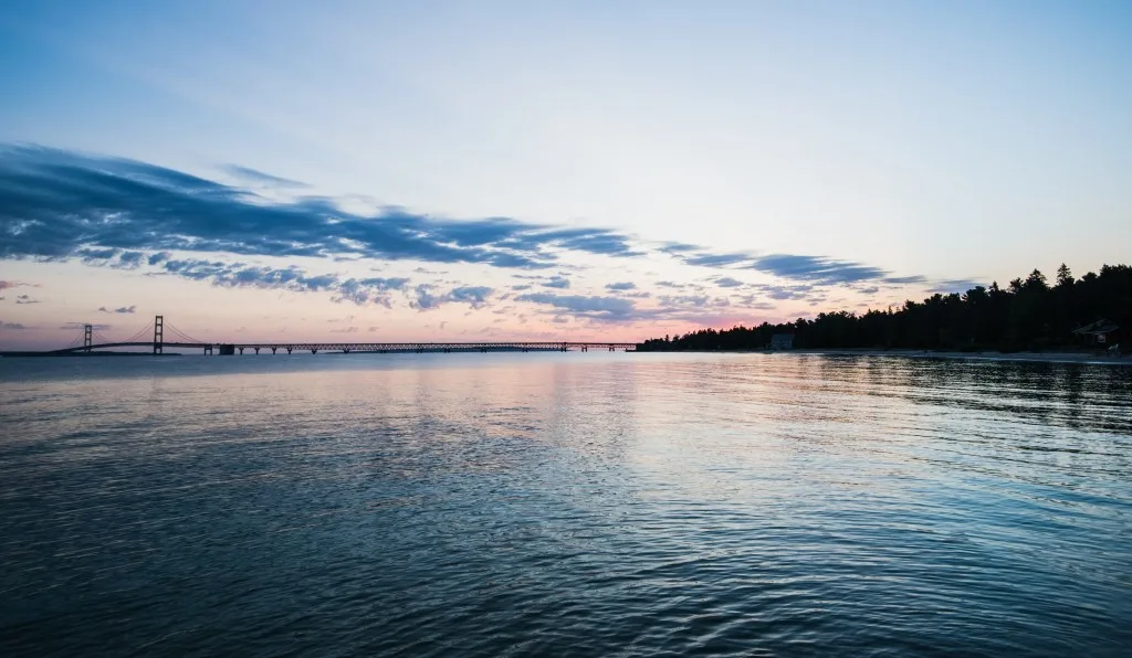 Sunset over bridge leading to Mackinac Island.