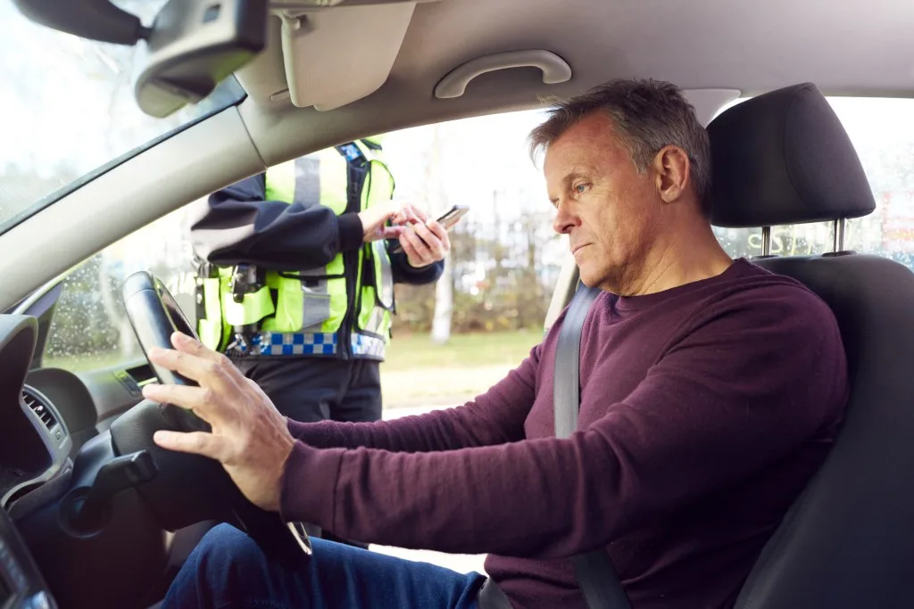 Man getting speeding ticket from police man