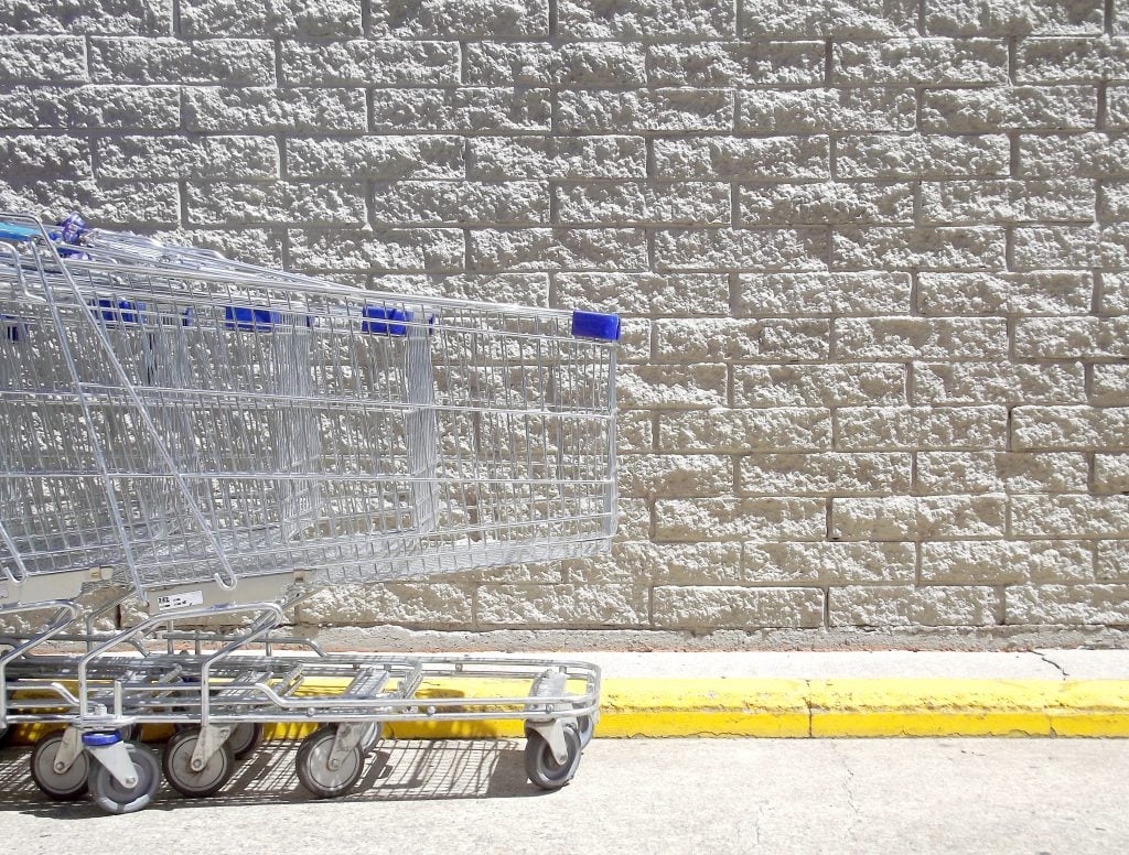 Walmart shopping carts lined up by the store.