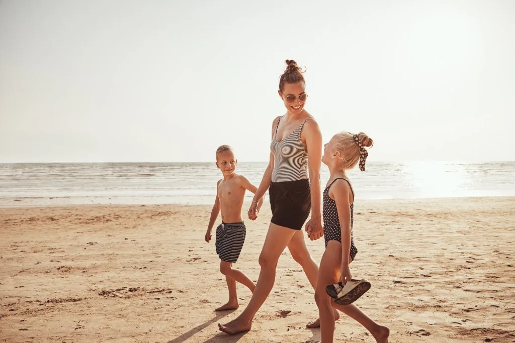 Mom walking with son and daughter on Galveston Beach