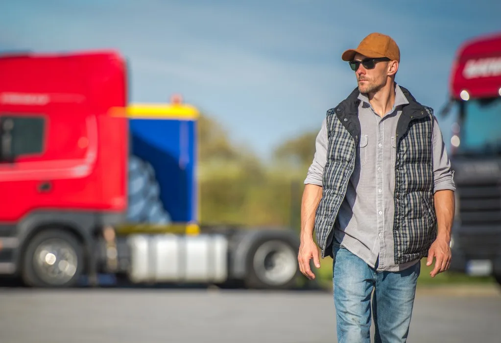 Male trucker walking by truck stop