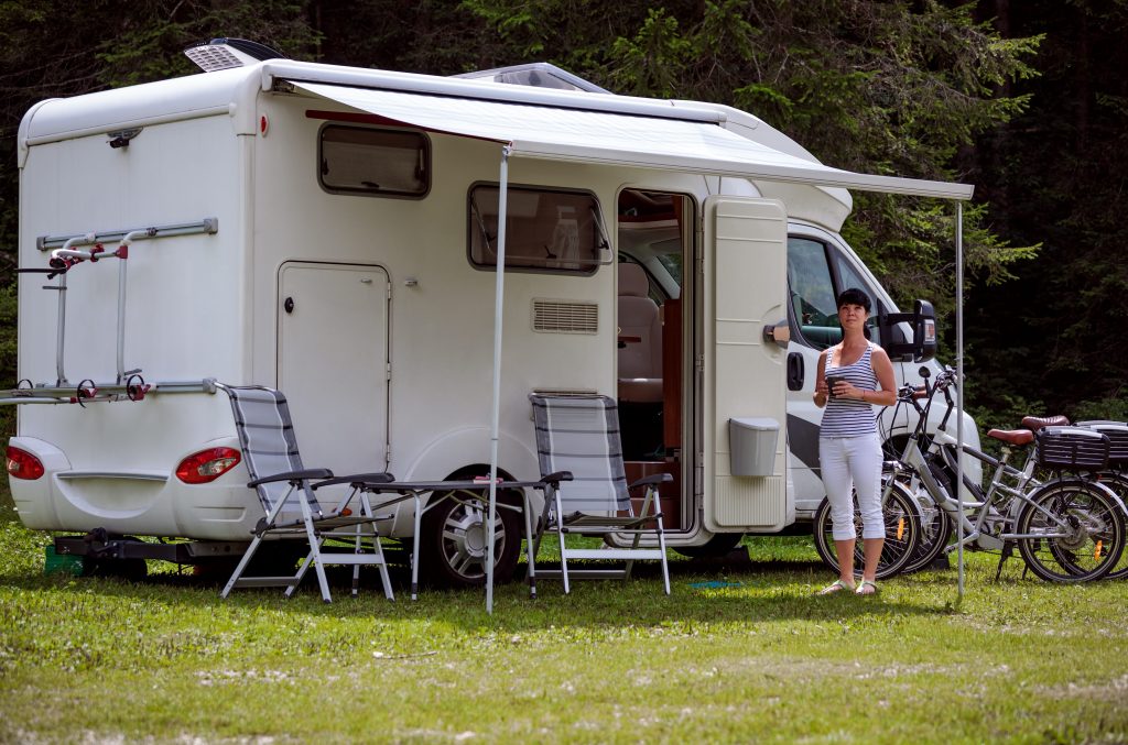 Woman smiling in front of RV