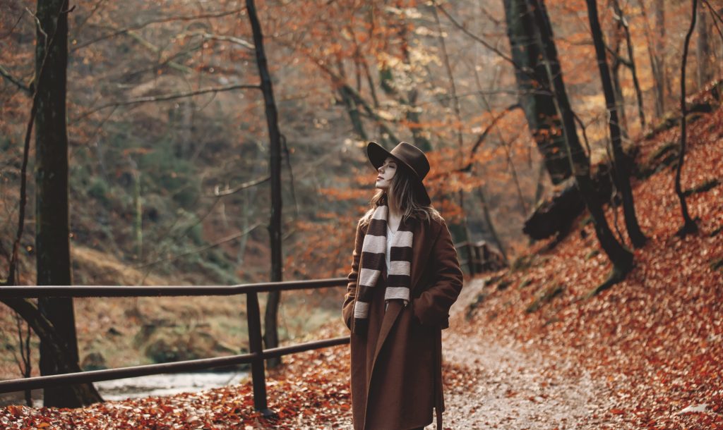 Woman walking through national park in the fall