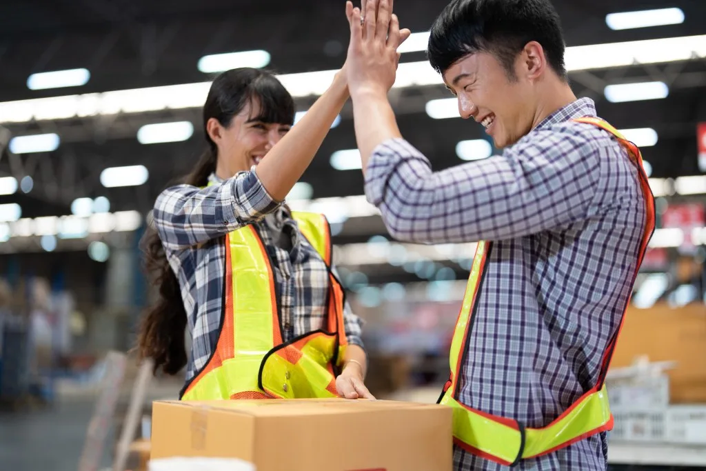 Two Lowe's employees high fiving each other