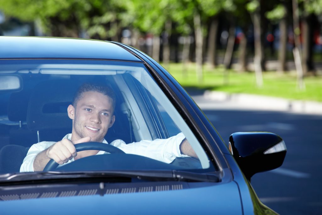 Man looking through windshield driving