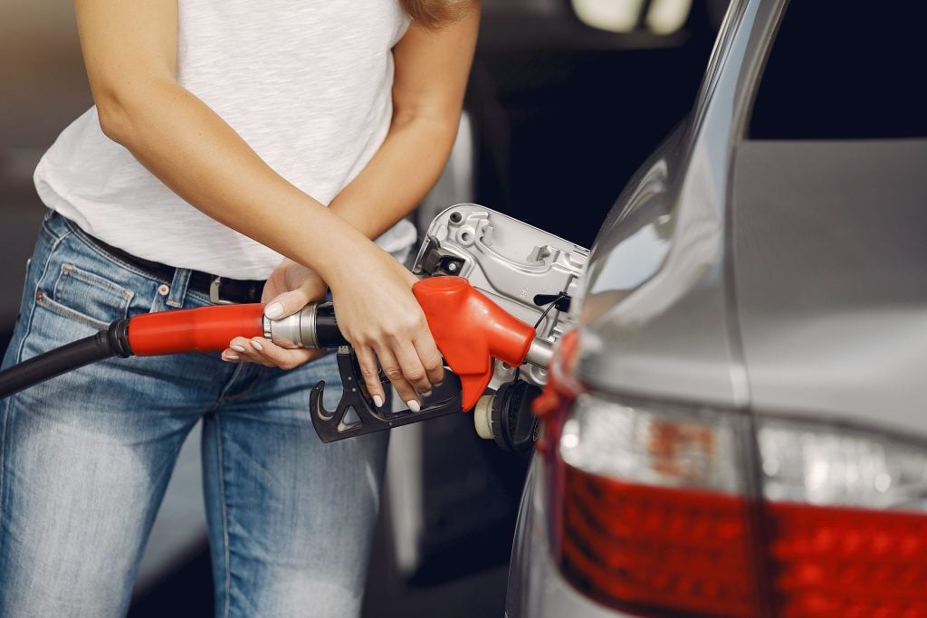 Woman putting gas into her car