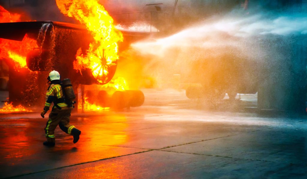 Firefighter fighting RV fire