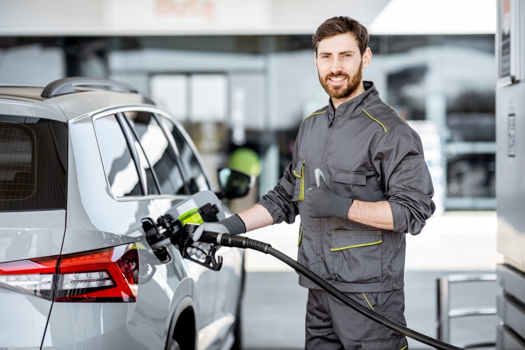 Man refilling car with gas