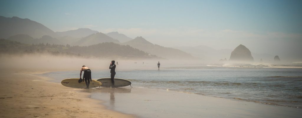 Surfers in the morning at Cannon Beach.