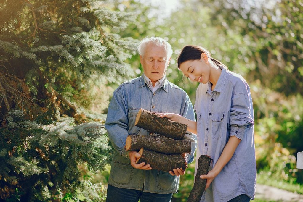 Grandfather and granddaughter looking for firewood 