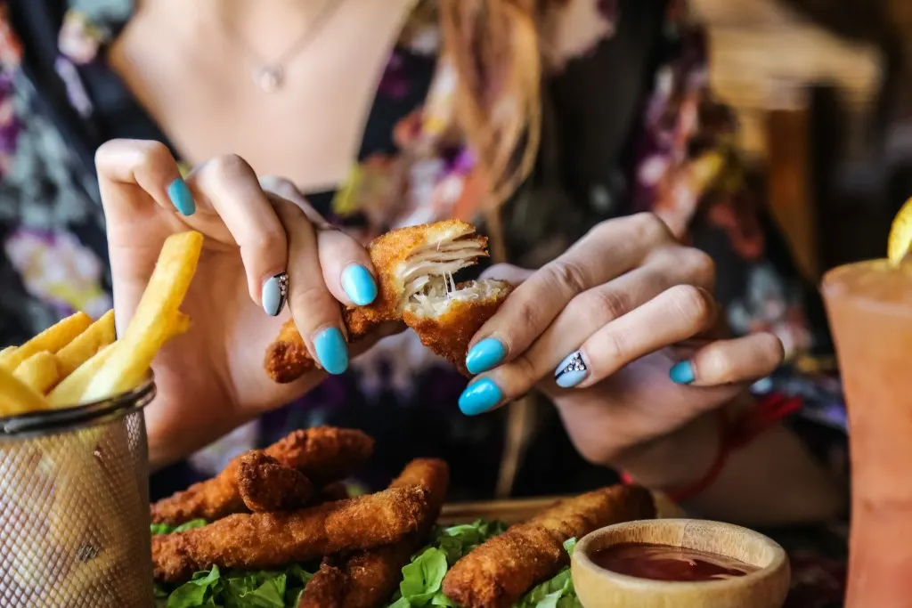 Woman eating Nashville Hot chicken