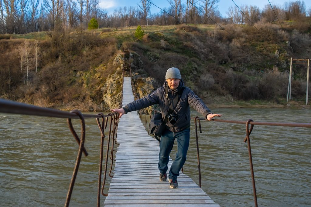 Man running across bridge from dangerous creature while hiking in Alabama