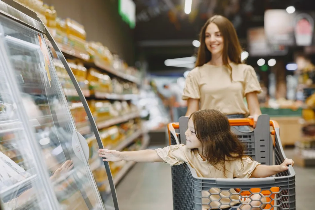 Mom and daughter grocery shopping at Publix