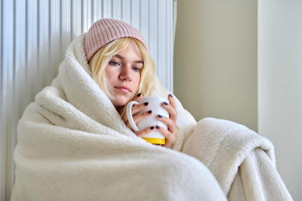 Girl in heated blanket sitting in RV