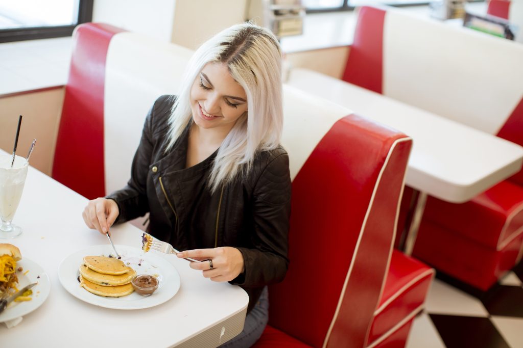 Woman eating in diner