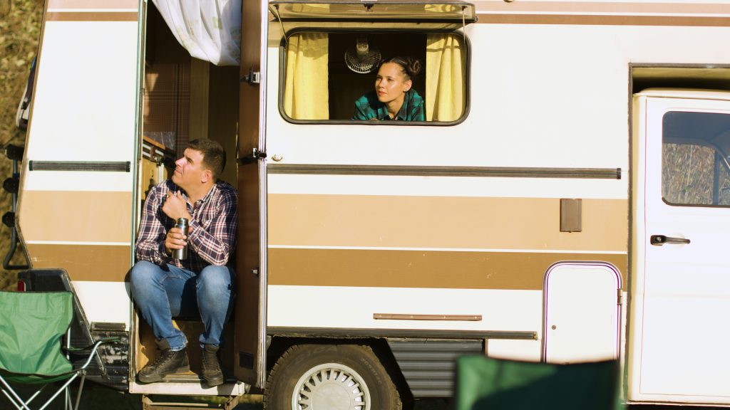 Couple looking out door and window in RV
