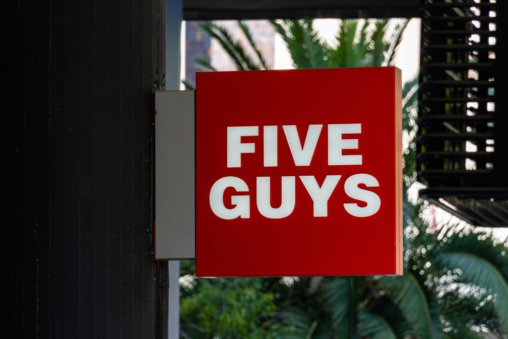 Five Guys restaurant sign on exterior of building