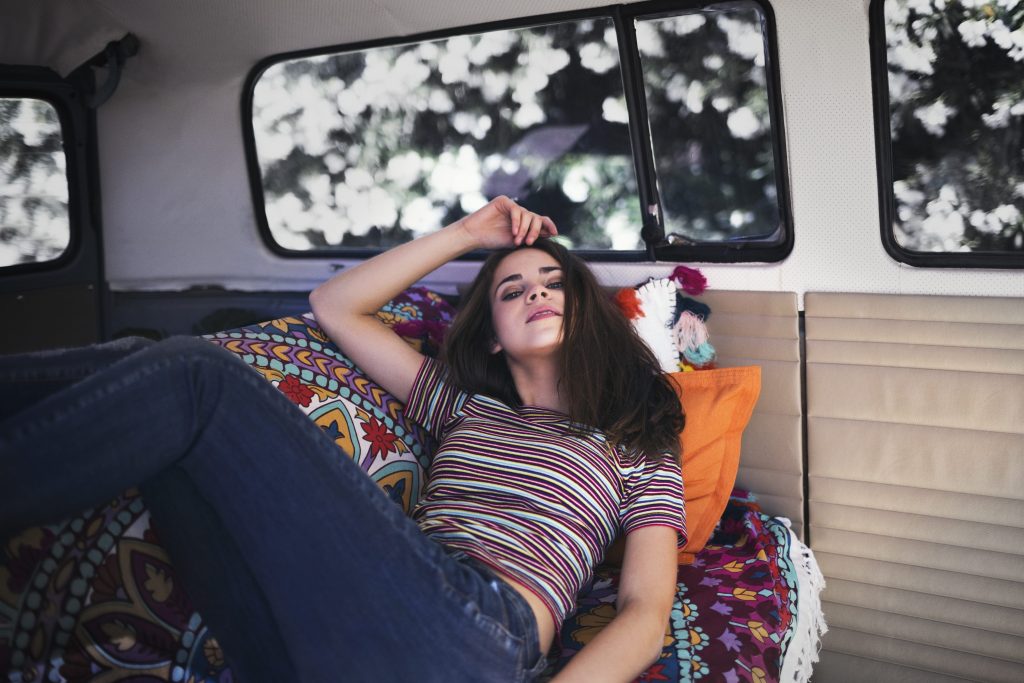 Girl laying on couch in tiny trailer