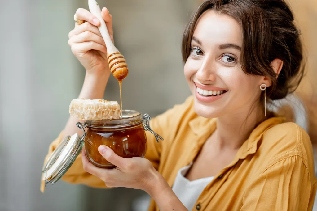 Women eating Mad Honey from a pot