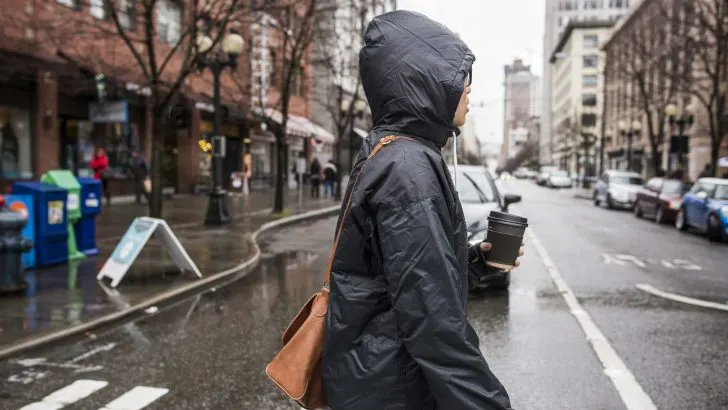 Woman crossing the street in the rain