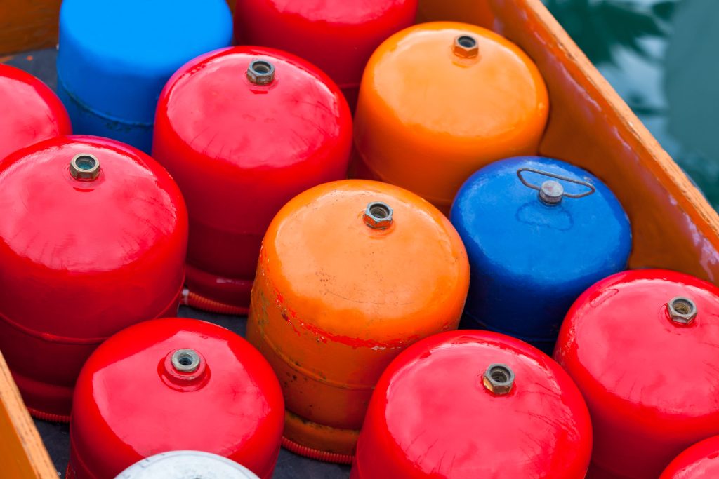 Colorful propane tanks in a pile