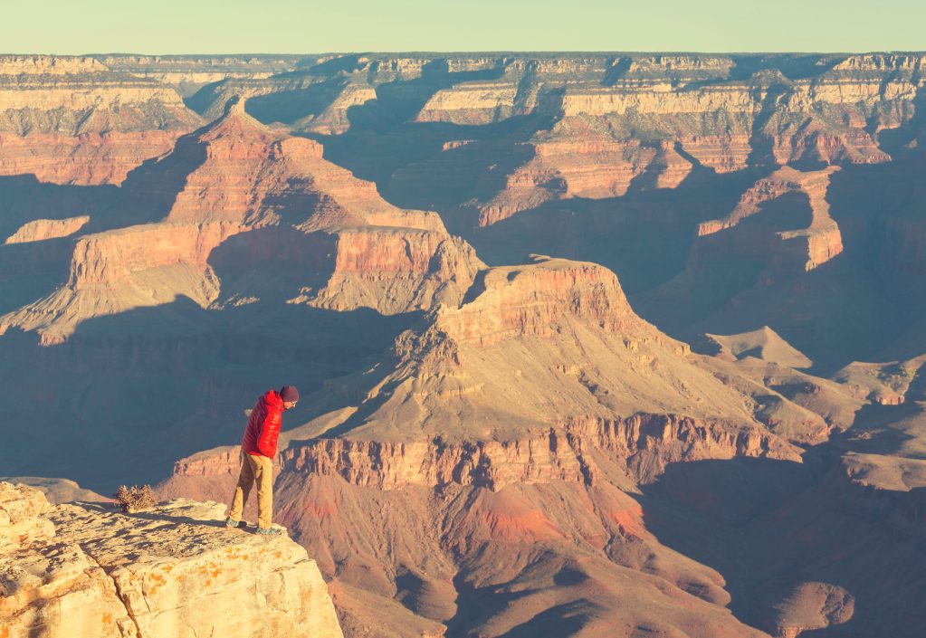 Man looking over the edge of the Grand Canyon