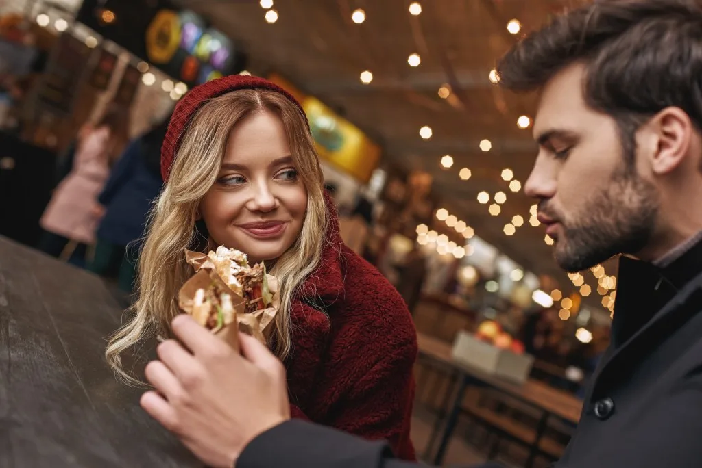Couple eating street food together