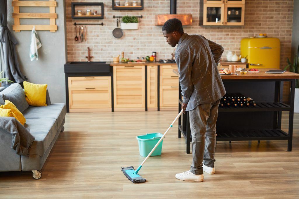 Man cleaning his hardwood floors