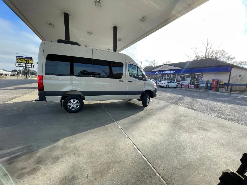 A photo of a van filling up at a Raceway gas station. 