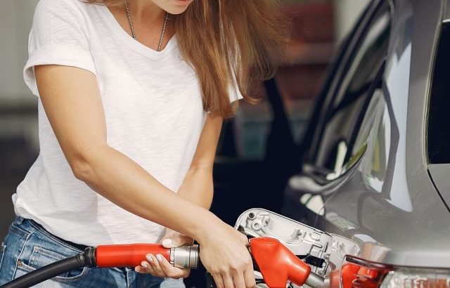 Woman refilling gas tank