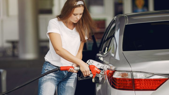 Woman refilling gas tank