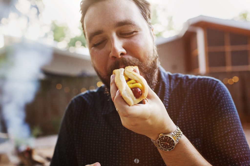 Man eating hot dog