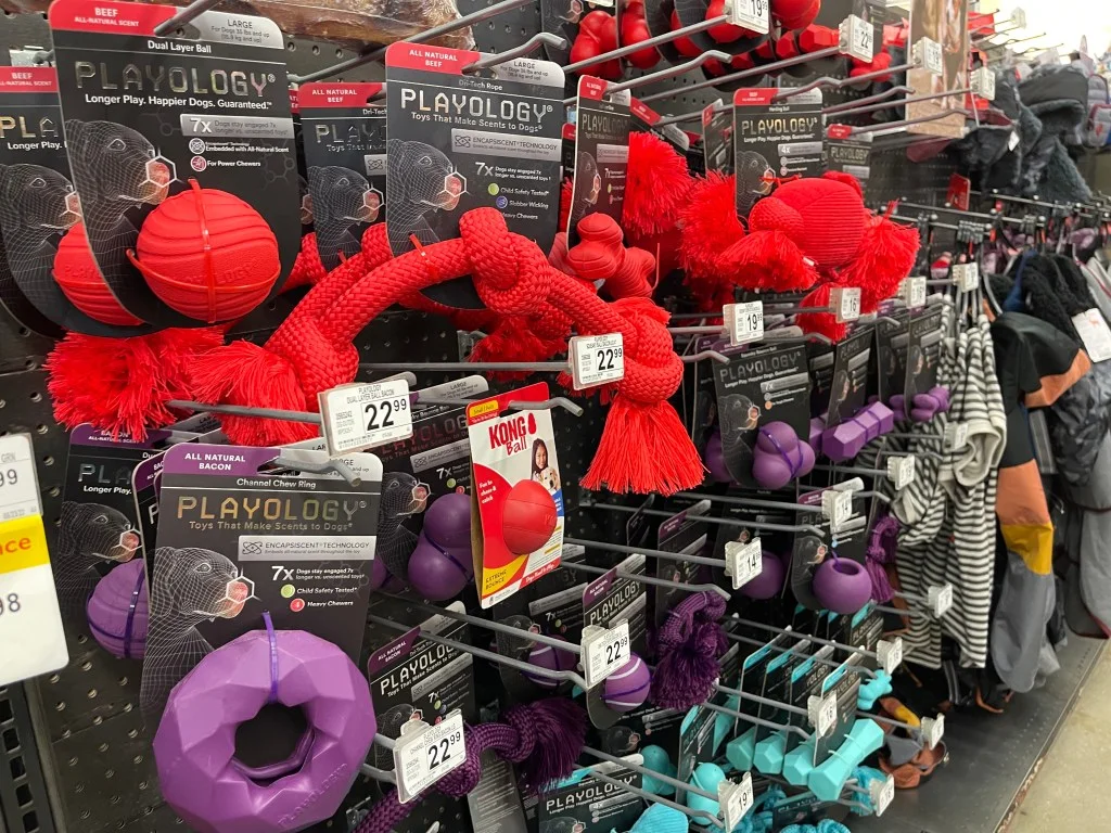 A photo of dog toys on a shelf in Petco.