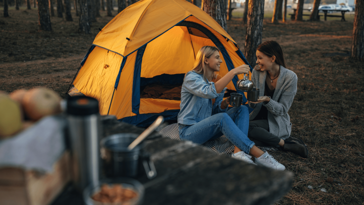 Two friends camping in a tent together