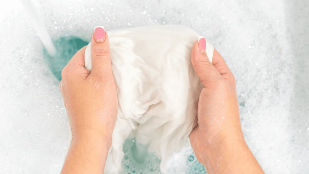 Woman washing white clothes without bleach