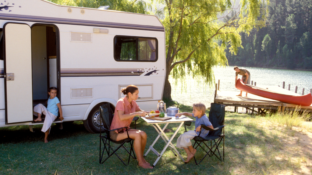 Woman and son in front of RV while camping