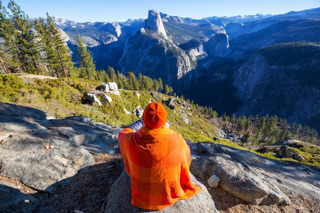 Man sitting in mountains in Yosemite