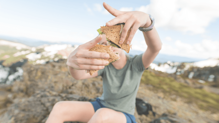 Hiker eating sandwich along the High Desert Food Trail