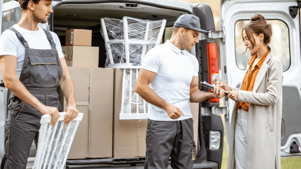 Two males helping woman move