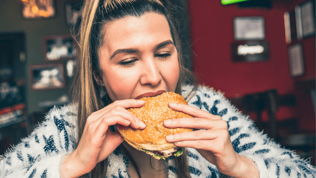 Woman eating Whataburger