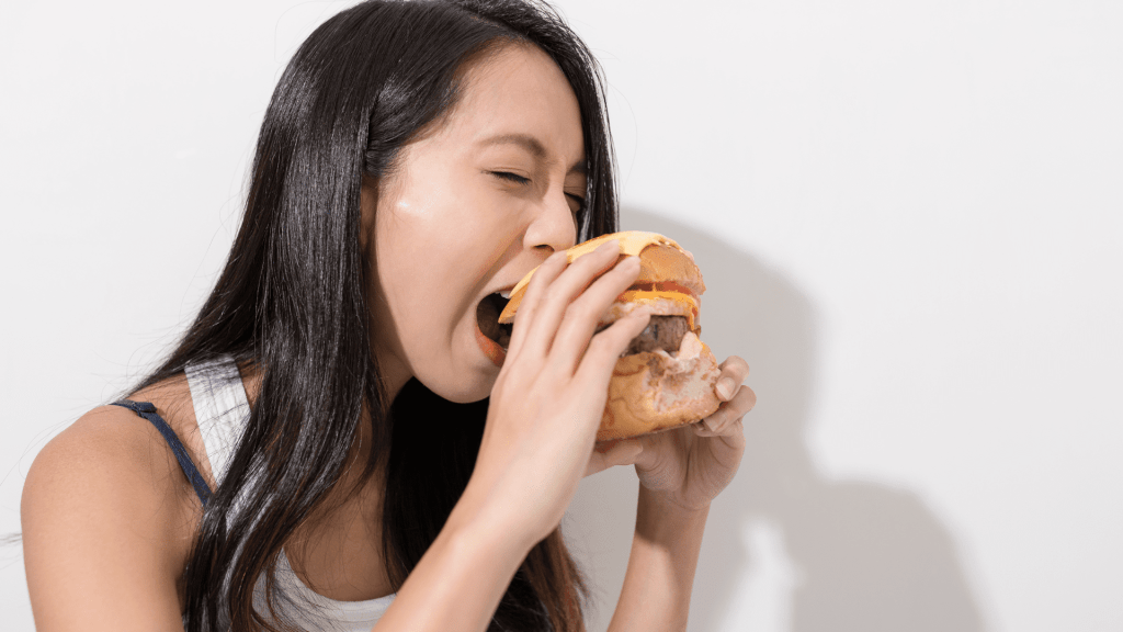 Woman eating Whataburger
