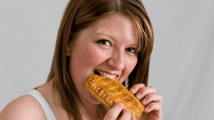 Woman eating a Michigan pasty