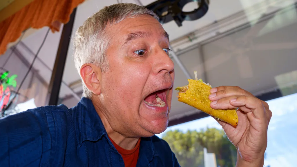 Man eating fast food tacos