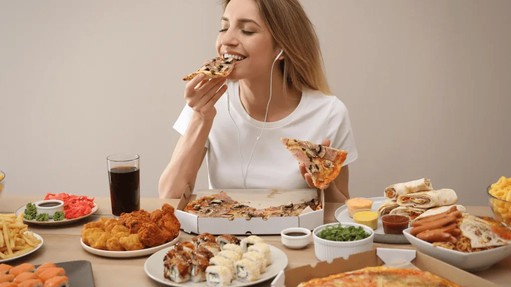 Woman eating unhealthy food on Fat Tuesday