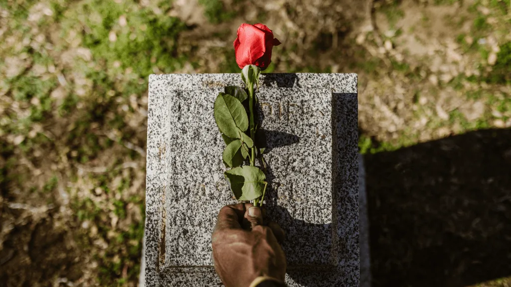 Placing flower on grave